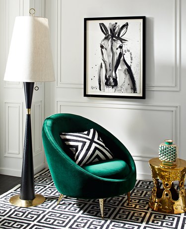 art deco living room with emerald green lounge chair in black and white room