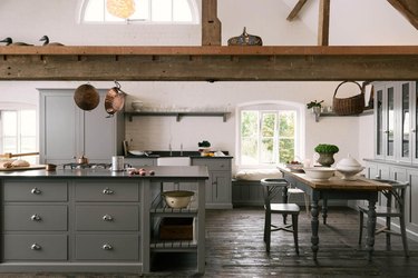 rustic farmhouse with dark kitchen floors of reclaimed wood and exposed ceiling beams