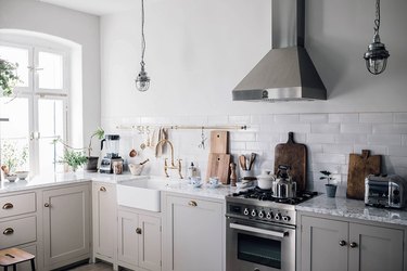traditional kitchen cabinet doors in kitchen with steel range hood and gray subway tile
