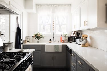 small kitchen with white countertops and gray cabinets