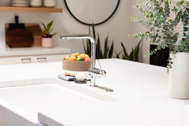 Kitchen countertop with sink and bowl of fruit