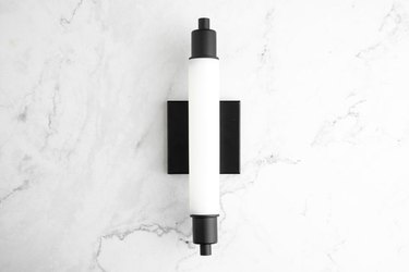 Art deco lighting in black and white details against marble backdrop