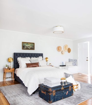 guest bedroom idea with upholstered headboard and vintage accents