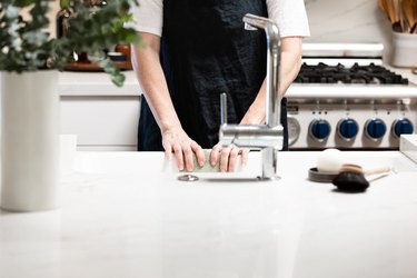 Person standing at kitchen sink