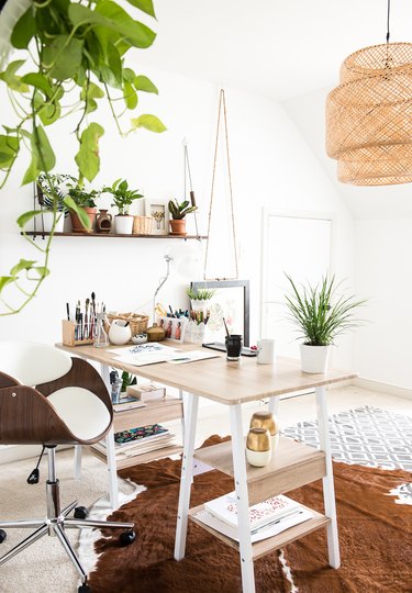 Boho office with bamboo chandelier and light wood desk
