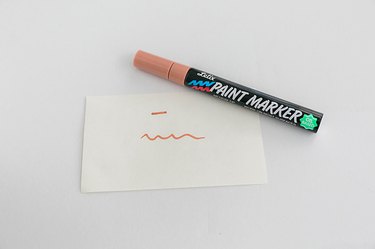 Practice using your paint marker on scrap paper.