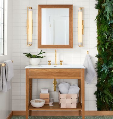 wooden open bathroom vanity in white bathroom with green tile floor