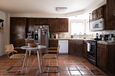kitchen with terra cotta tiles and stone backsplash