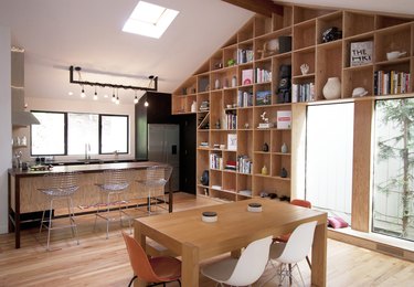 two-toned wood industrial kitchen island with skylight and french doors