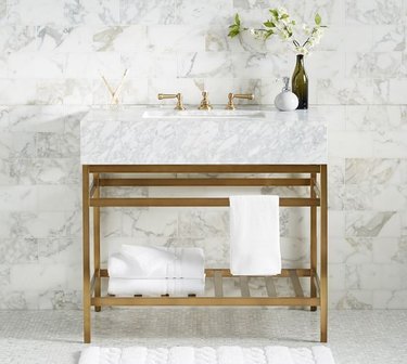 brass and marble open bathroom vanity