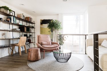 living room with brown floors and white walls