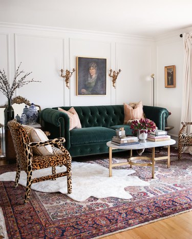 Hollywood Regency living room with green velvet couch and leopard print chairs