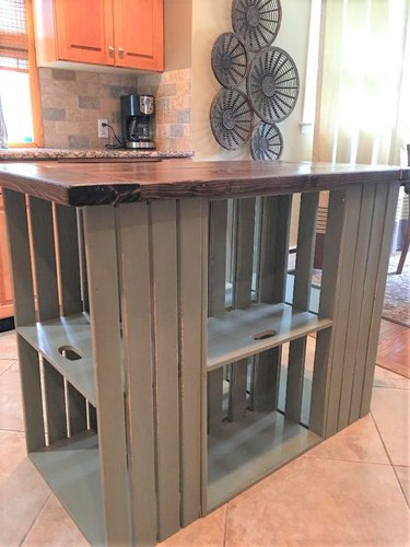 Farmhouse crate island with wood top in suburban kitchen