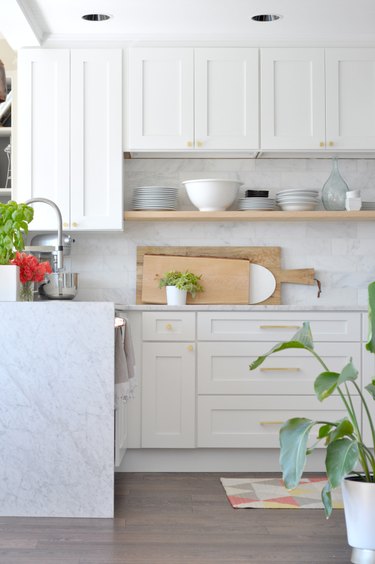 Exposed wood shelving and marble white countertops