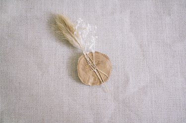 Dried florals hot glued to back of gold wax seal