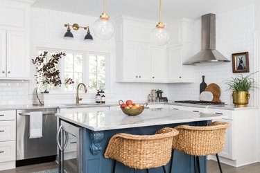 Quartzite white countertop and a blue island