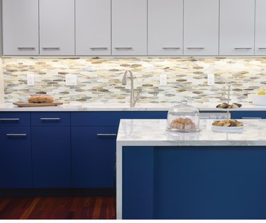 kitchen space with gray and navy blue cabinets