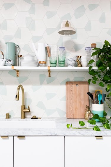 white kitchen with hexagonal tiles and undermount sink