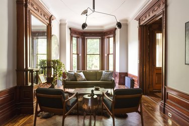 old school living room with wooden paneling and vintage furniture