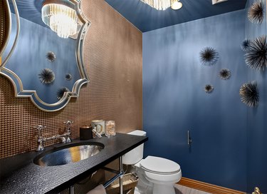 bathroom space with blue wall and metallic wall