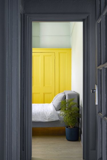 bright-yellow accent color in a hip London rental bedroom