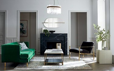 living room in art deco style with green couch and black chair