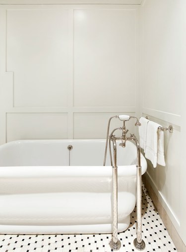 white art deco bathroom by Chango & Co. with mosaic floor tile