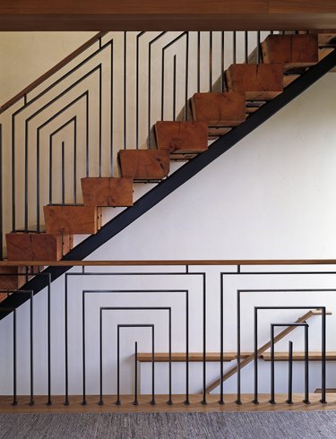 Art Deco staircase with geometric details and reclaimed wood steps