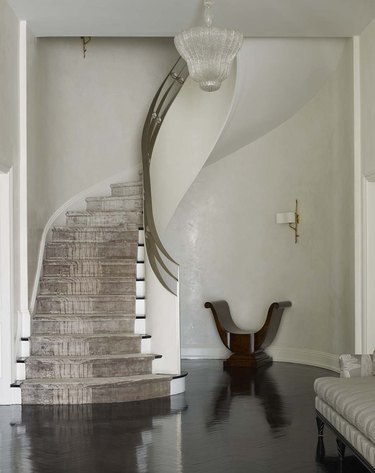art deco staircase with brass railings and velvet carpet