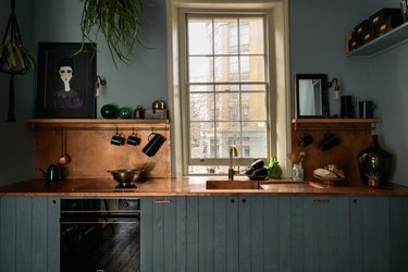 green beadboard cabinets with copper worktop.