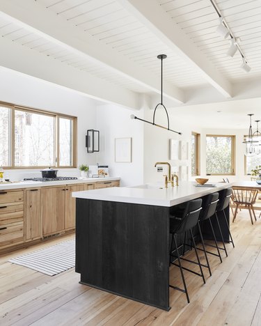 Black kitchen island with outlet stools