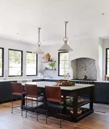 Dark traditional kitchen island with storage and leather bar stools