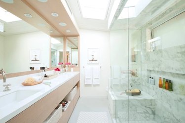 modern bathroom with full-wall mirrors over double vanity