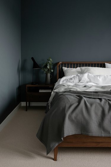 spindle bed frame in dark minimalist bedroom
