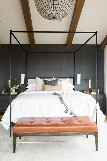 bedroom with black walls and a four-poster bed