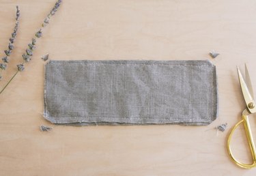 Corners clipped on gray linen eye pillow that's inside-out