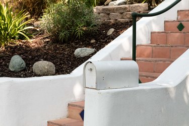 Mailbox next to stairs and yard on a slope