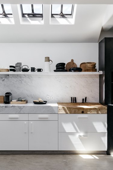 marble kitchen with thick countertops and wooden butchers block