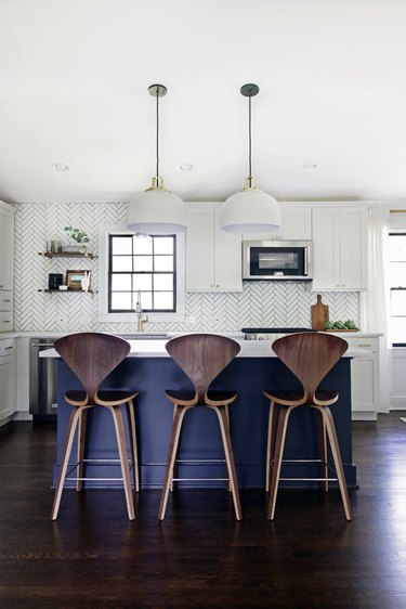 navy blue kitchen island ideas for small kitchens with wooden bar chairs and white pendant lights