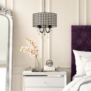 Hollywood Regency Bedroom with crystal chandelier over nightstand