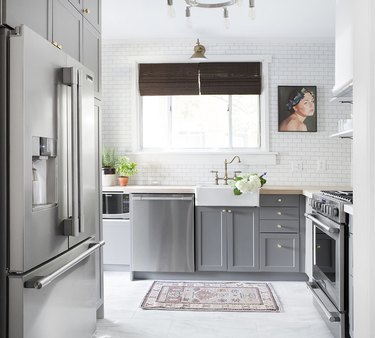 Pittsburgh kitchen with white kitchen floor tiles and gold faucet