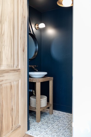 Small bathroom with blue walls and tiled floor