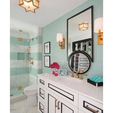 hollywood regency bathroom with blue green penny tile