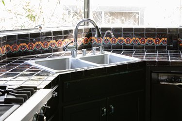 corner kitchen sink with black tile
