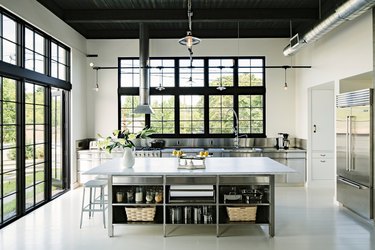 large stainless steel kitchen island with open shelving