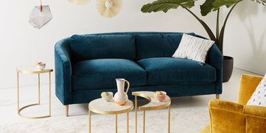 Curved blue velvet couch