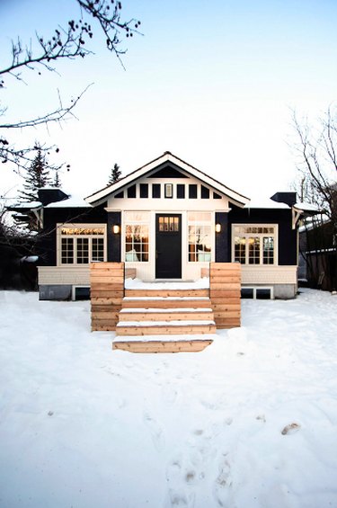black craftsman house with white trim and natural materials