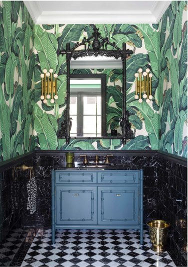 hollywood regency bathroom with banana leaf wallpaper and bamboo vanity
