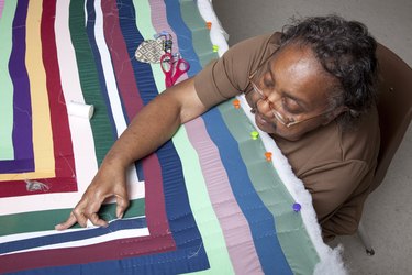 woman working on Gee's Bend style quilt