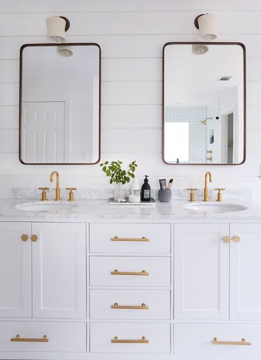 bathroom wall lighting idea with wall sconces above mirrors